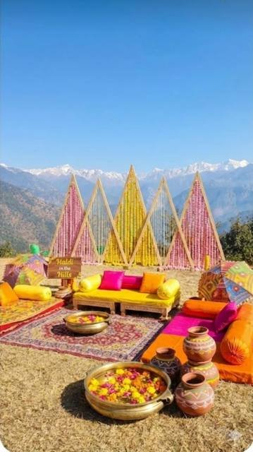 Haldi in the Hills decor with marigold triangles and mountain view