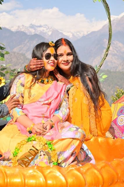 Two women sharing a haldi moment