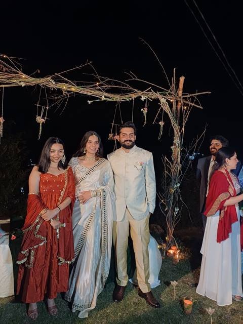 Sangeet night under a fairy-lit floral arch